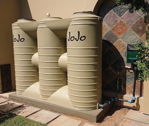 Three JoJo tanks installed with pump and pipework at a residential property