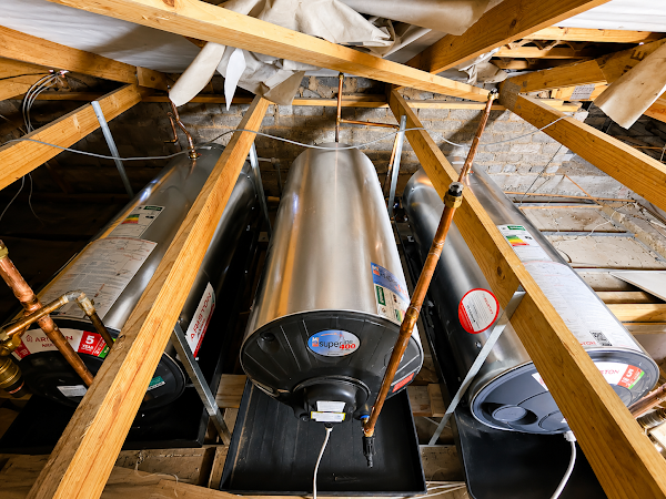 Geysers installed in a roof space with copper pipework and drip trays